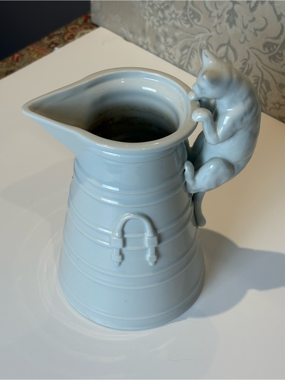 Vintage White Porcelain pitcher with a cat as a handle. Holds 20oz.